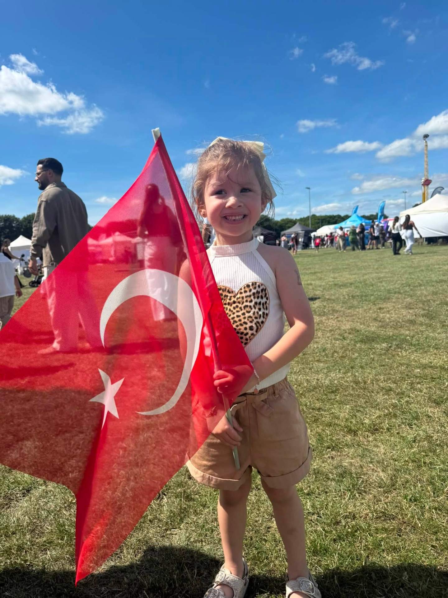 Young girl holding a Turkish flag at the festival